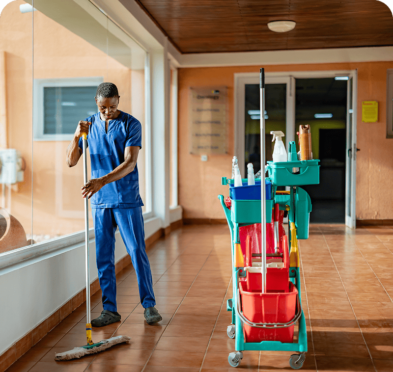 Janitor mopping hallway floor