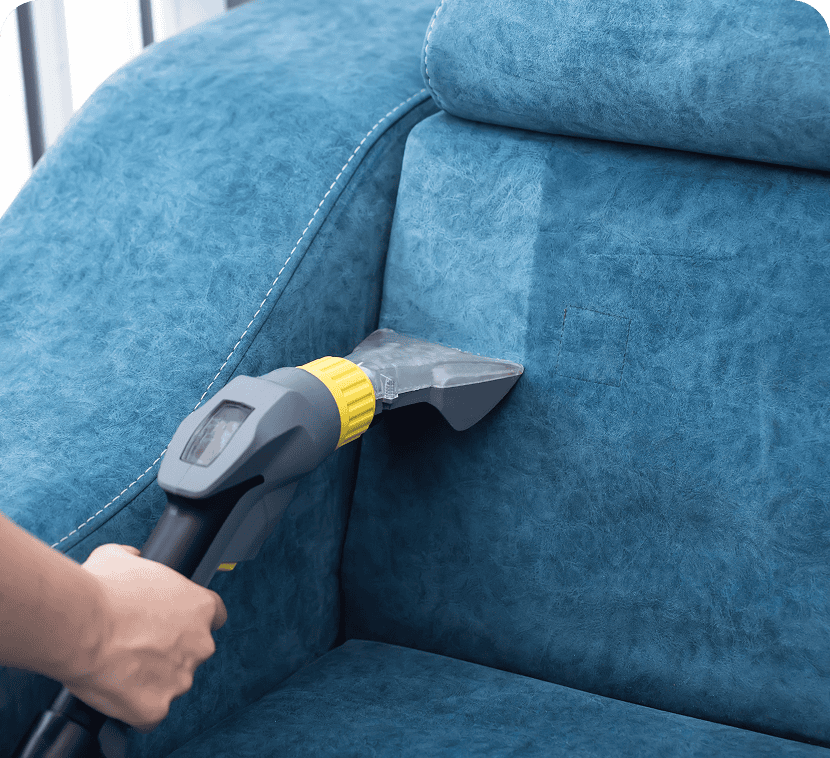 Vacuum cleaning a blue sofa