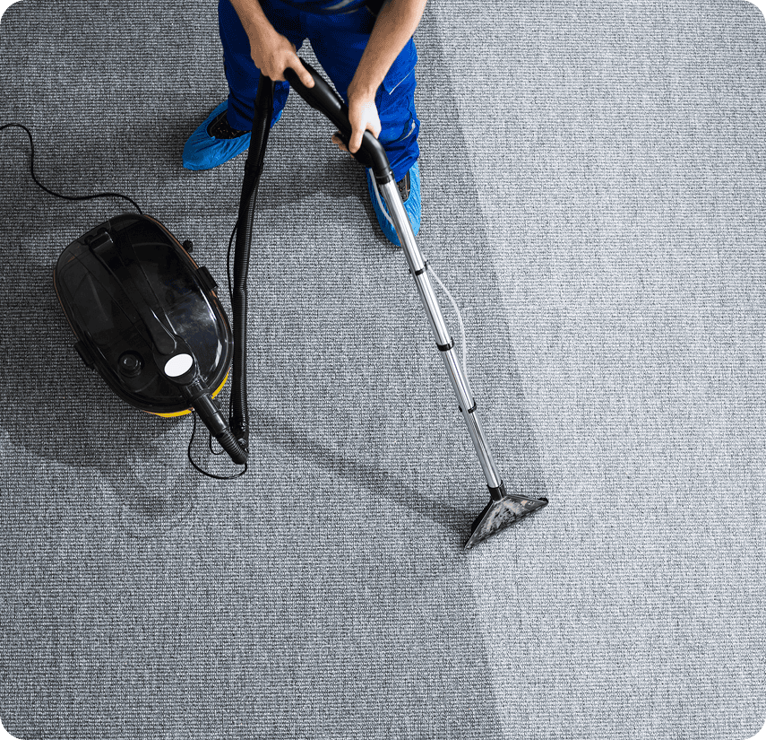 Person cleaning carpet with vacuum