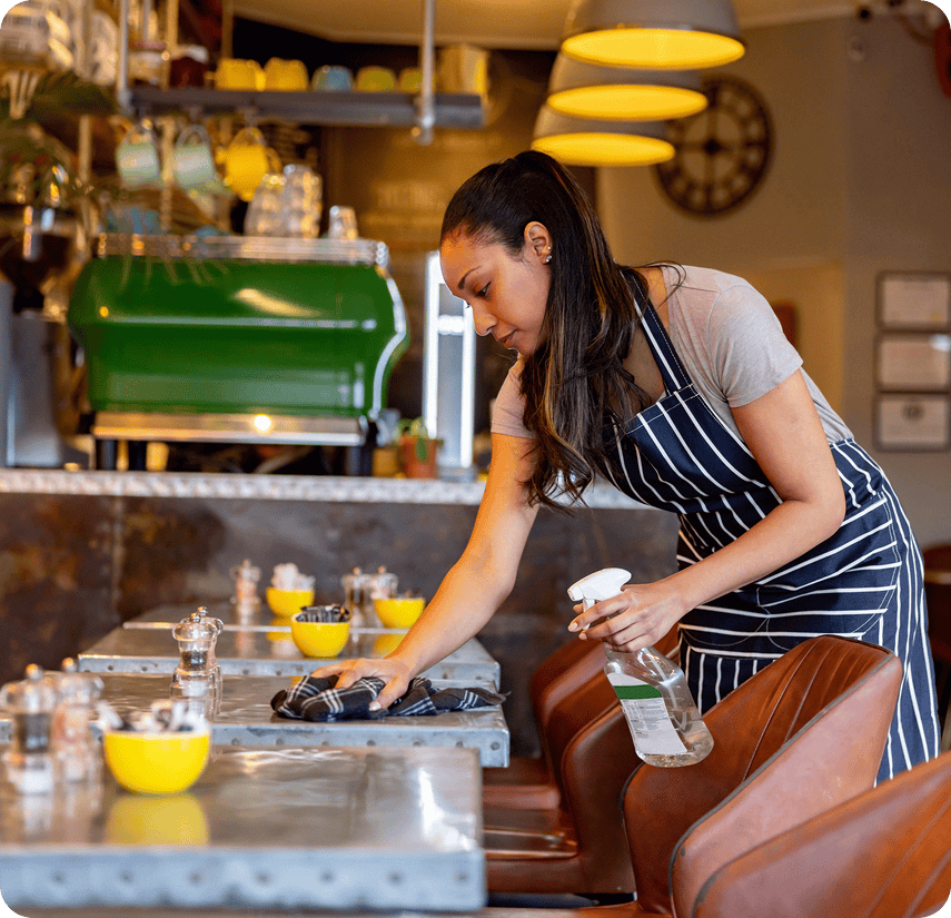 Woman cleaning a cafe table